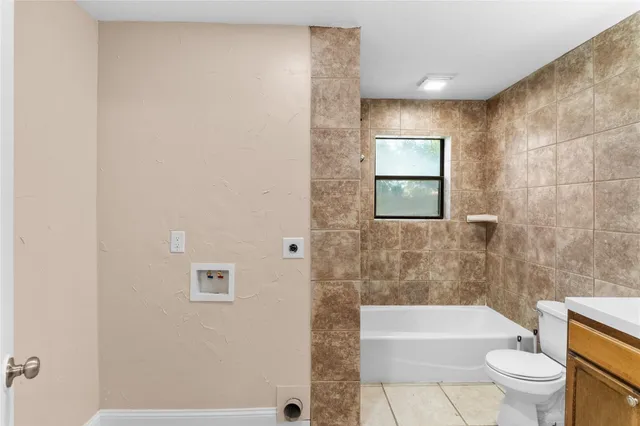 a bathroom with a toilet a sink and bathtub