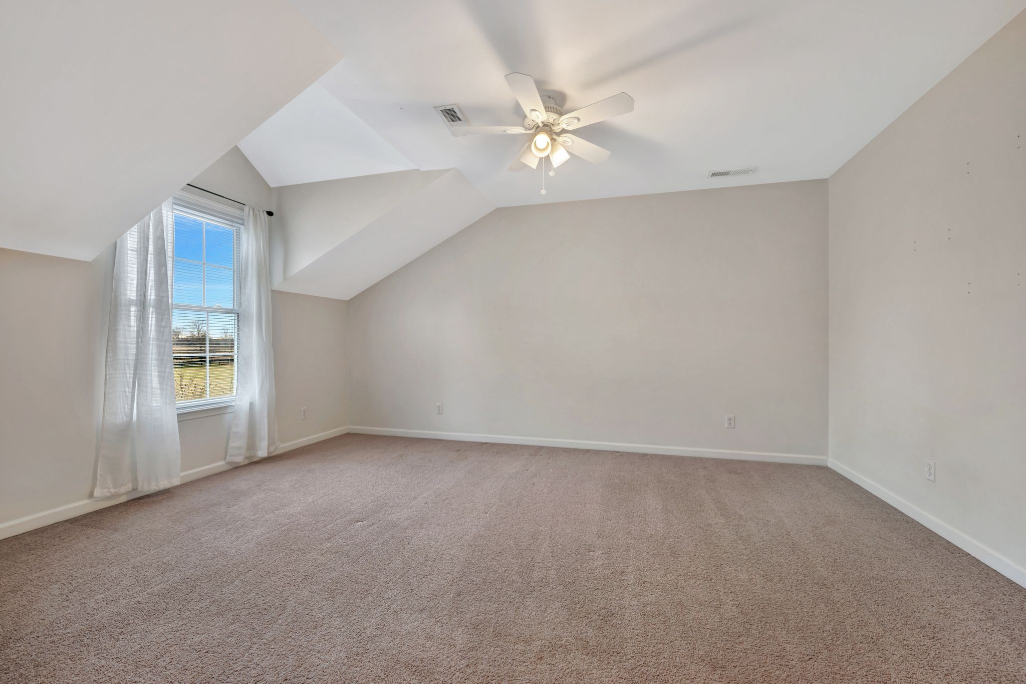 1576 Old Hillsboro Road Franklin, TN 37069 - Photo 33 of 57 an empty room with windows and chandelier fan