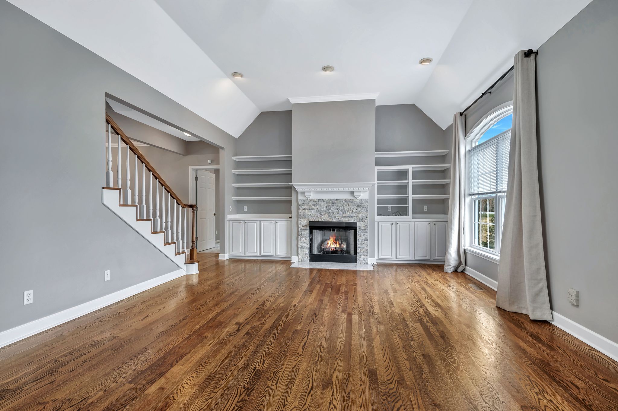 1576 Old Hillsboro Road Franklin, TN 37069 - Photo 8 of 57 a view of an empty room with wooden floor fireplace and a window