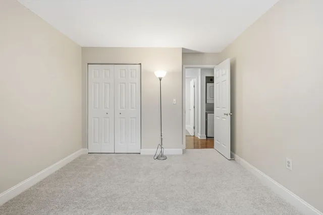 an empty room with closet area