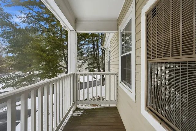 a view of a house with a yard and potted plants