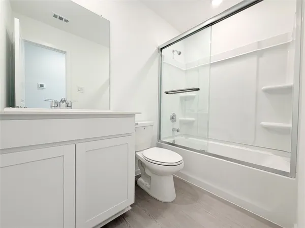 a bathroom with a sink mirror toilet and shower