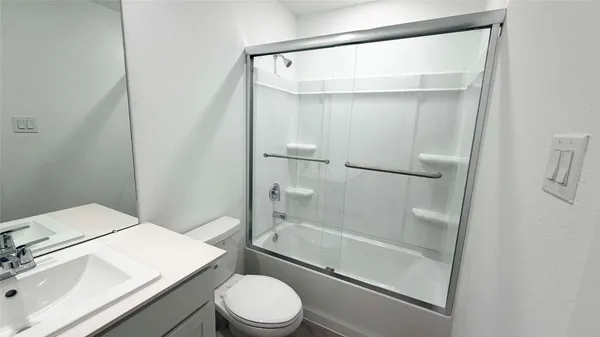 a bathroom with a shower and toilet