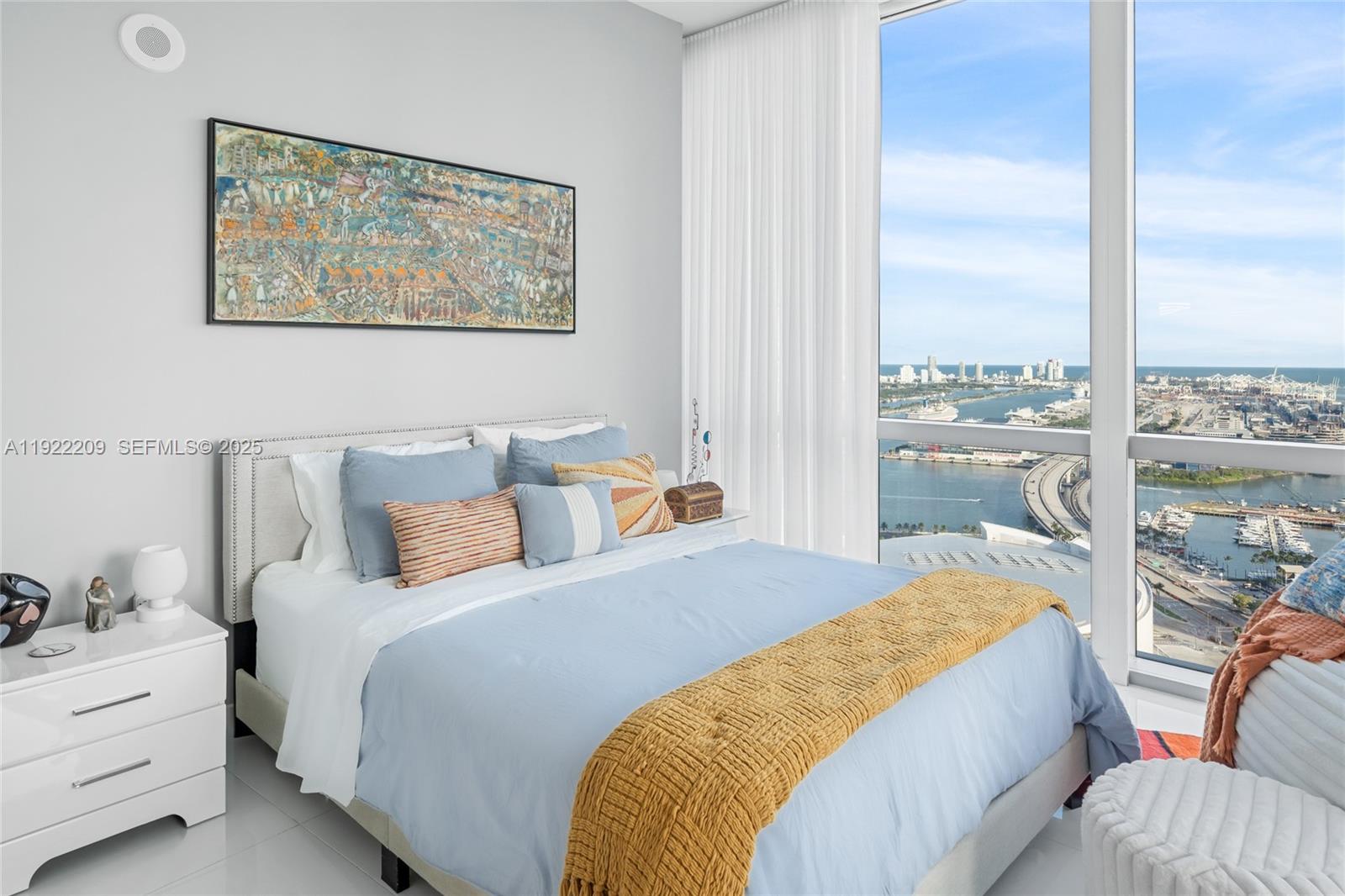 851 Northeast 1st Avenue, Unit 3911 Miami, FL 33132 - Photo 18 of 75 a bedroom with a bed and glass window