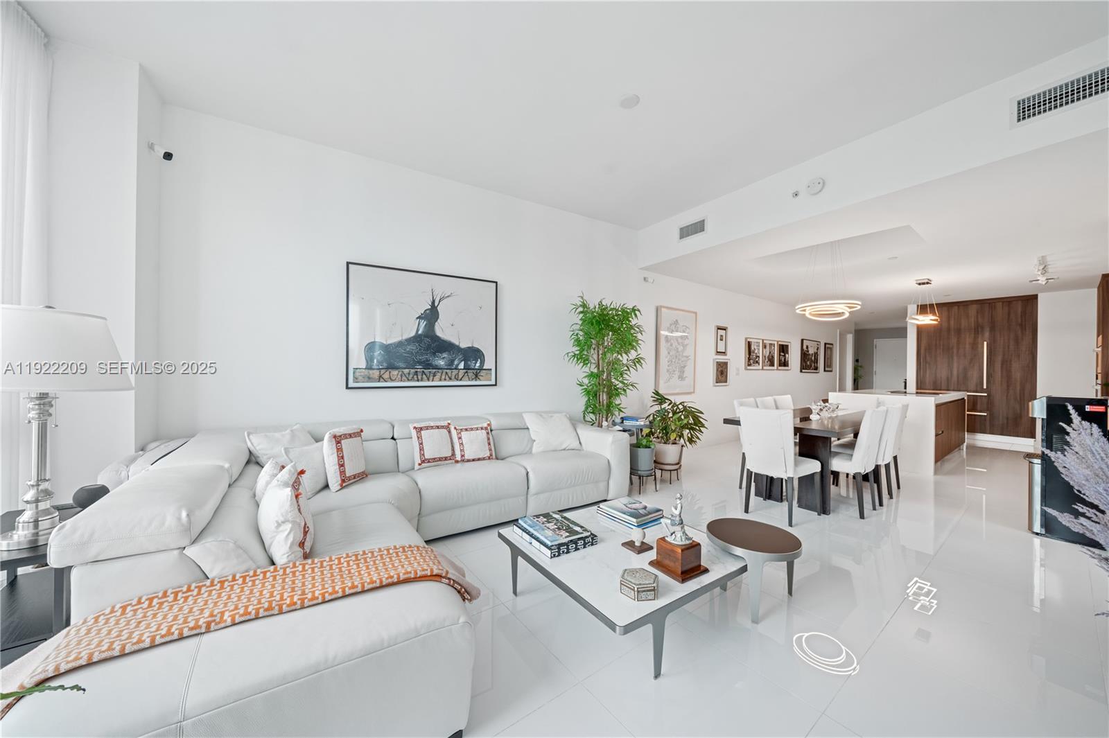 851 Northeast 1st Avenue, Unit 3911 Miami, FL 33132 - Photo 2 of 75 a living room with furniture potted plant and kitchen view