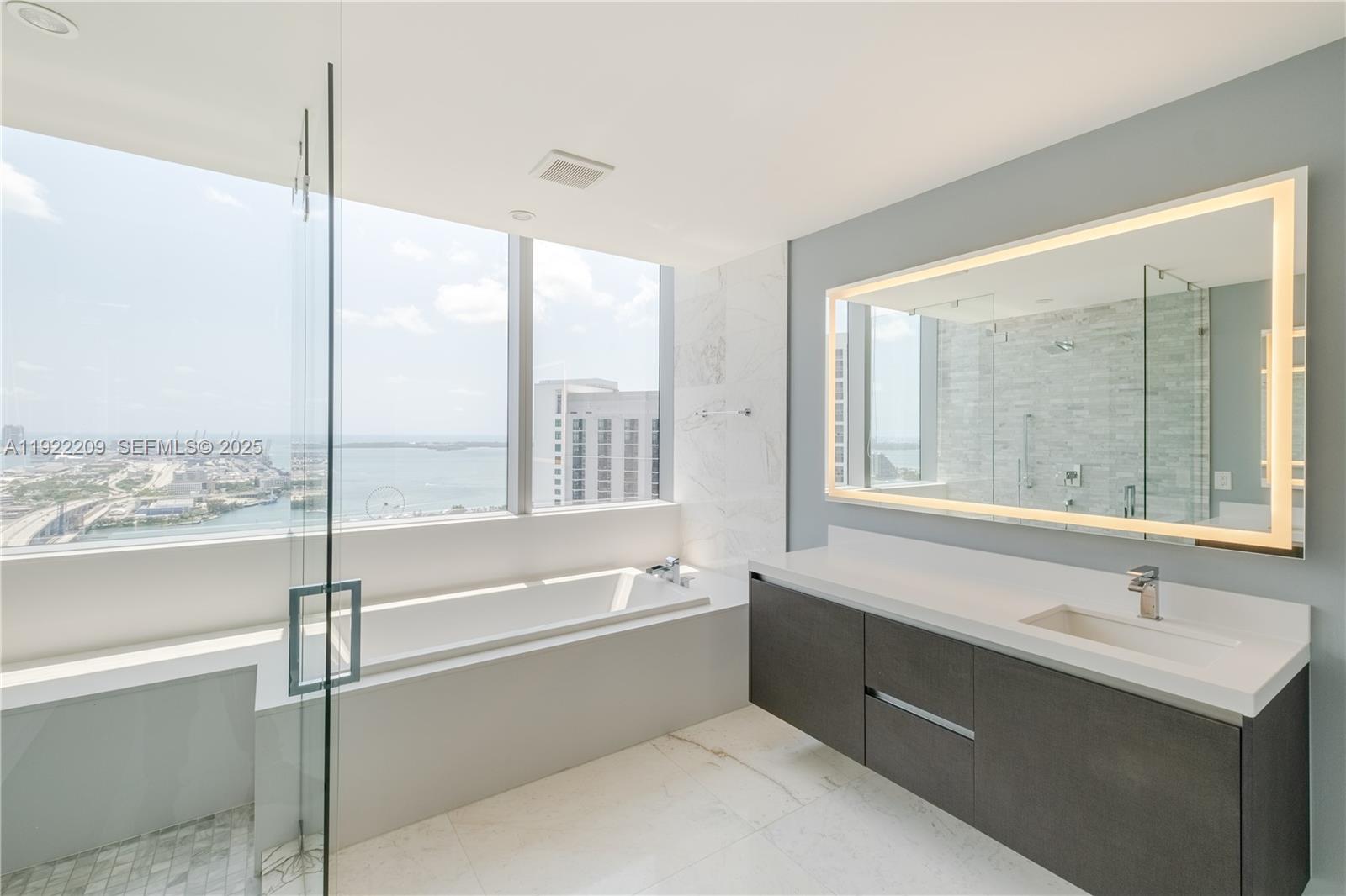 851 Northeast 1st Avenue, Unit 3911 Miami, FL 33132 - Photo 21 of 75 a bathroom with a bathtub and a sink