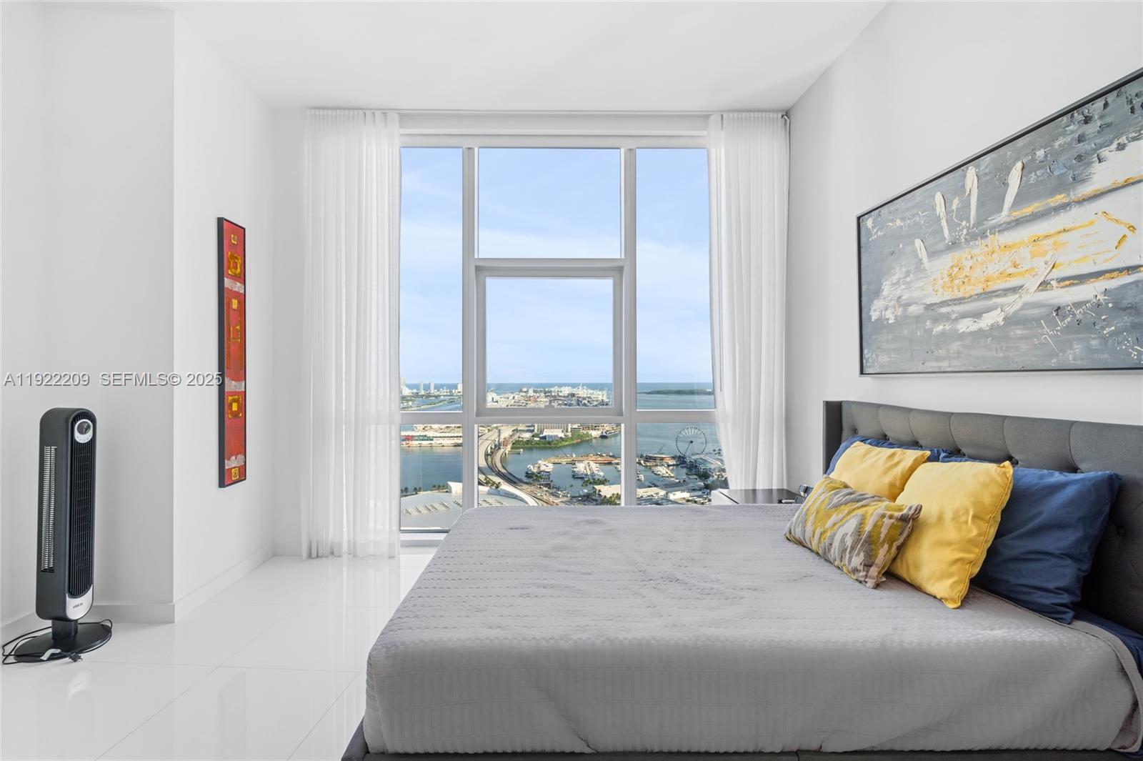 851 Northeast 1st Avenue, Unit 3911 Miami, FL 33132 - Photo 28 of 75 a bedroom with a bed and a flat screen tv