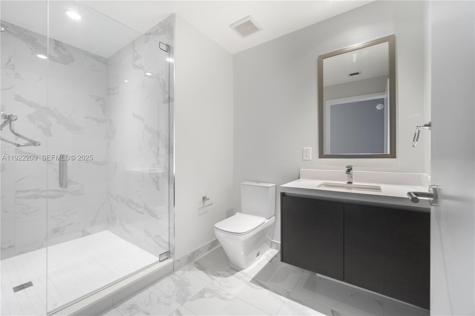 851 Northeast 1st Avenue, Unit 3911 Miami, FL 33132 - Photo 29 of 75 a bathroom with a sink toilet and shower