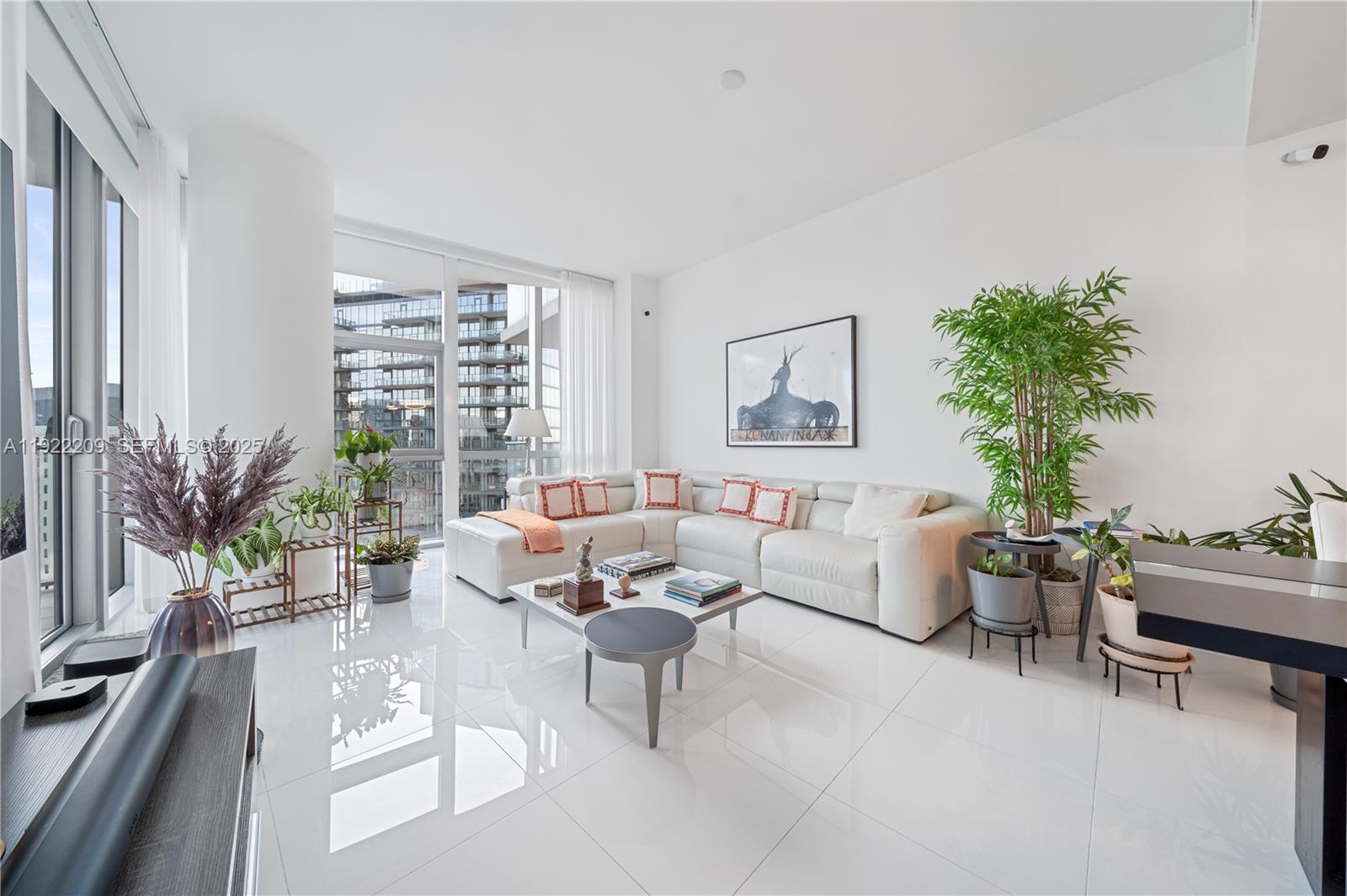 851 Northeast 1st Avenue, Unit 3911 Miami, FL 33132 - Photo 3 of 75 a living room with furniture and a potted plant