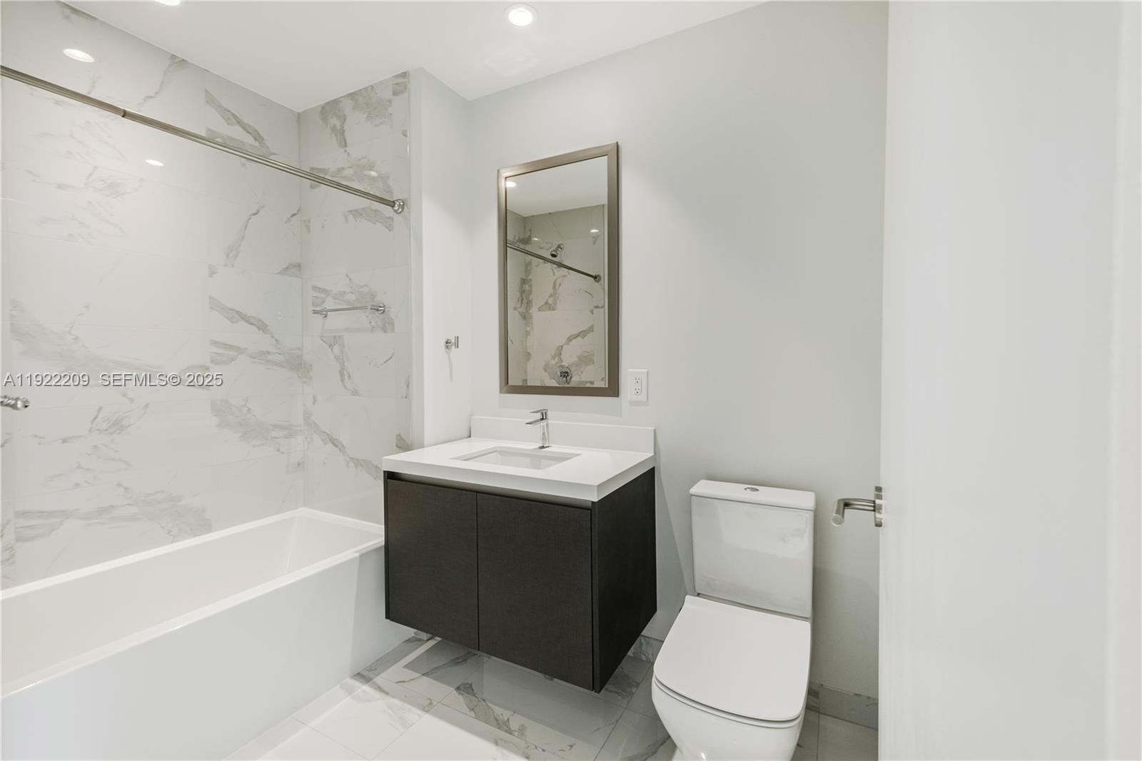 851 Northeast 1st Avenue, Unit 3911 Miami, FL 33132 - Photo 36 of 75 a bathroom with a sink a toilet and a bathtub