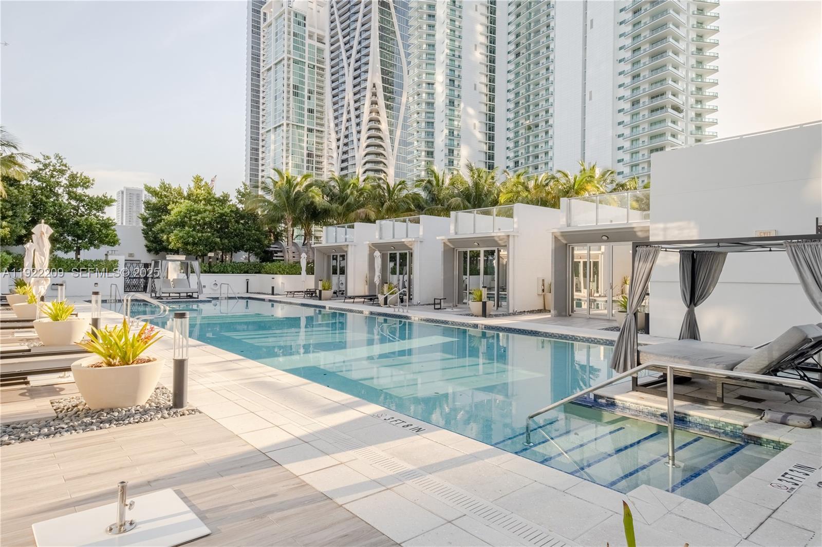 851 Northeast 1st Avenue, Unit 3911 Miami, FL 33132 - Photo 57 of 75 a view of a swimming pool with a lounge chairs