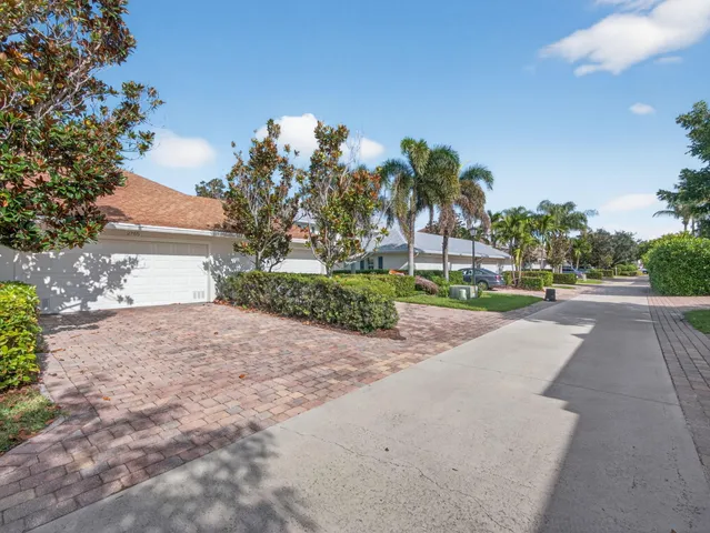 a front view of a house with a yard and a garage