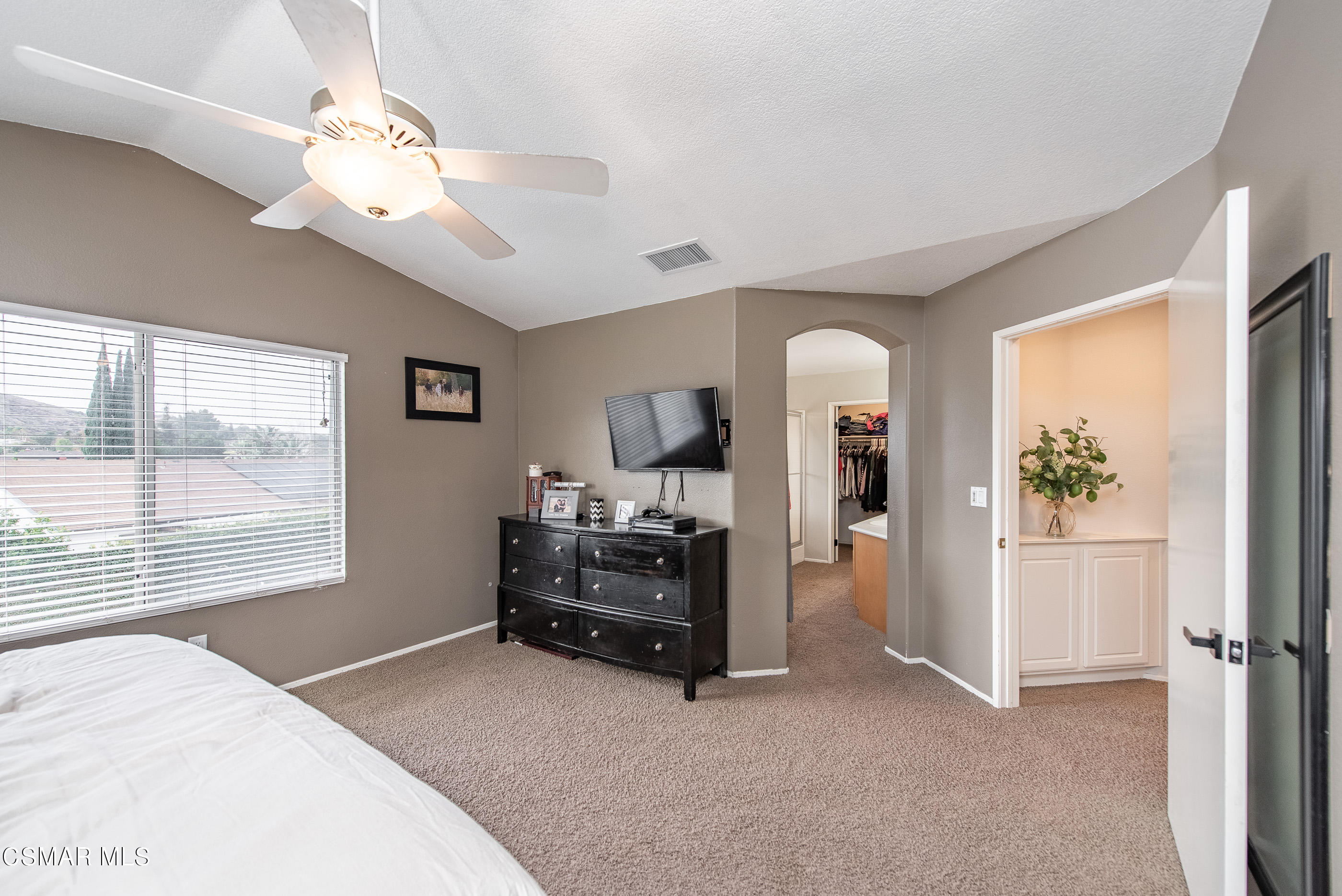 987 Roldan Avenue Simi Valley, CA 93065 - Photo 22 of 42 a bedroom with a bed and a chandelier