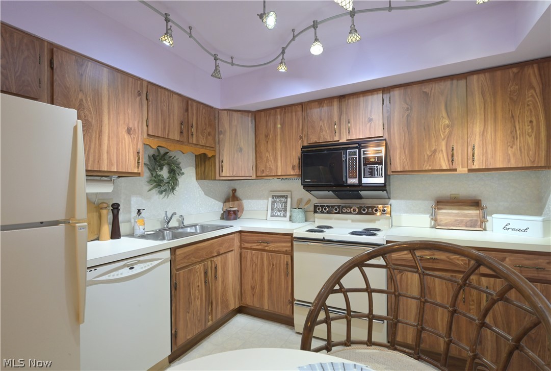 22962 Maple Ridge Road, Unit 206 North Olmsted, OH 44070 - Photo 7 of 33 Kitchen featuring track lighting, sink, and white appliances