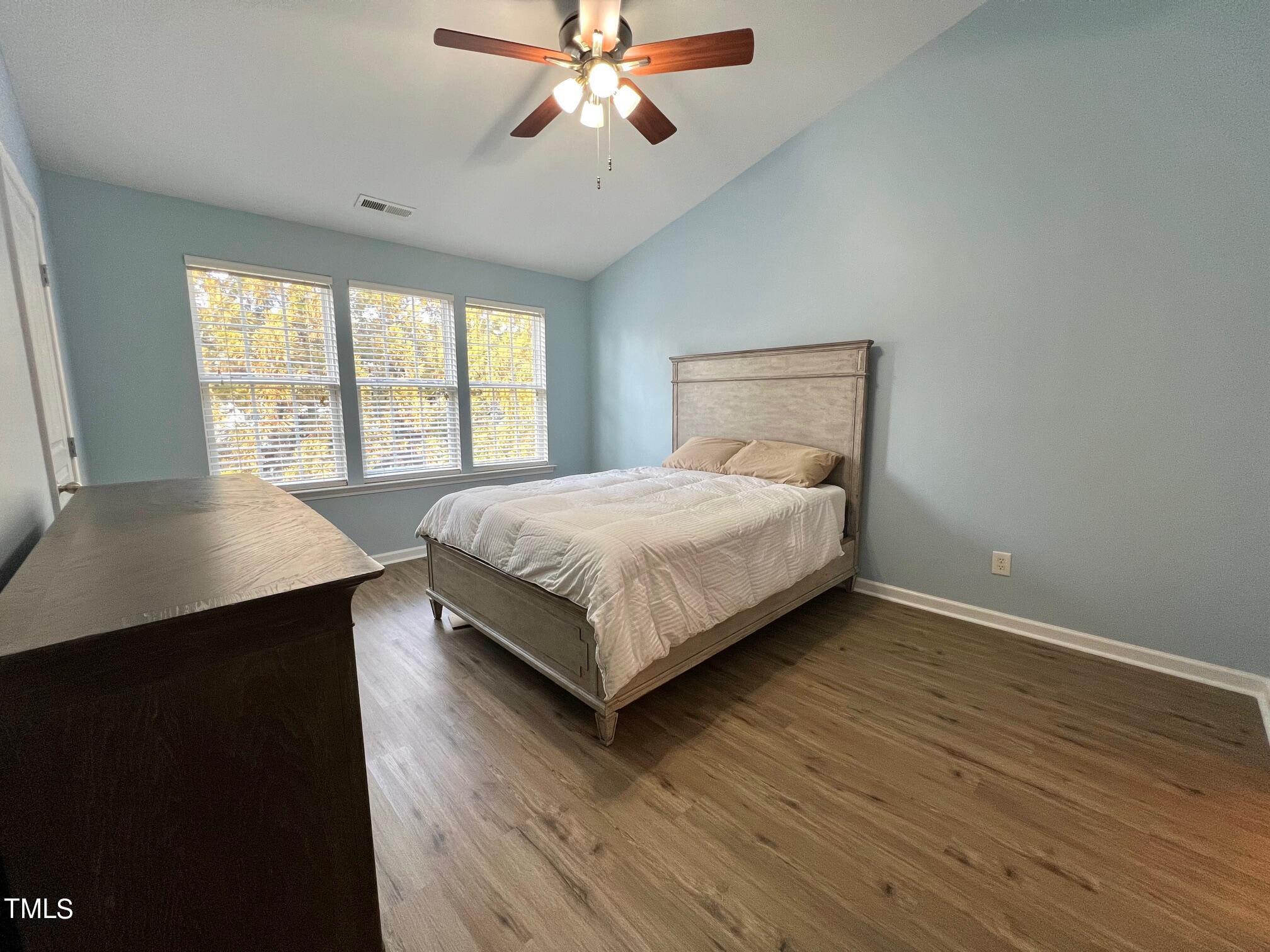 7652 Winners Edge Street Raleigh, NC 27617 - Photo 11 of 16 a bedroom with a bed and window