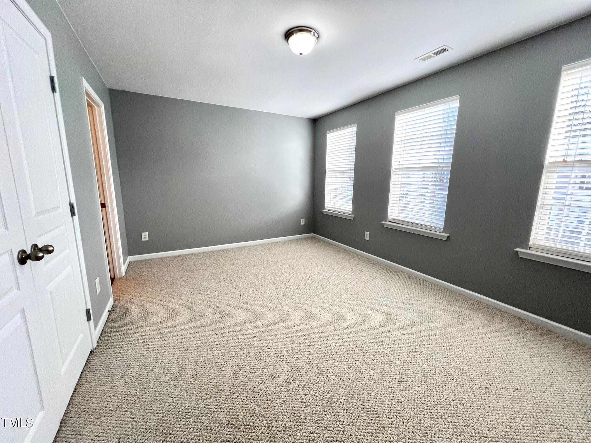 7652 Winners Edge Street Raleigh, NC 27617 - Photo 14 of 16 a view of an empty room with a window