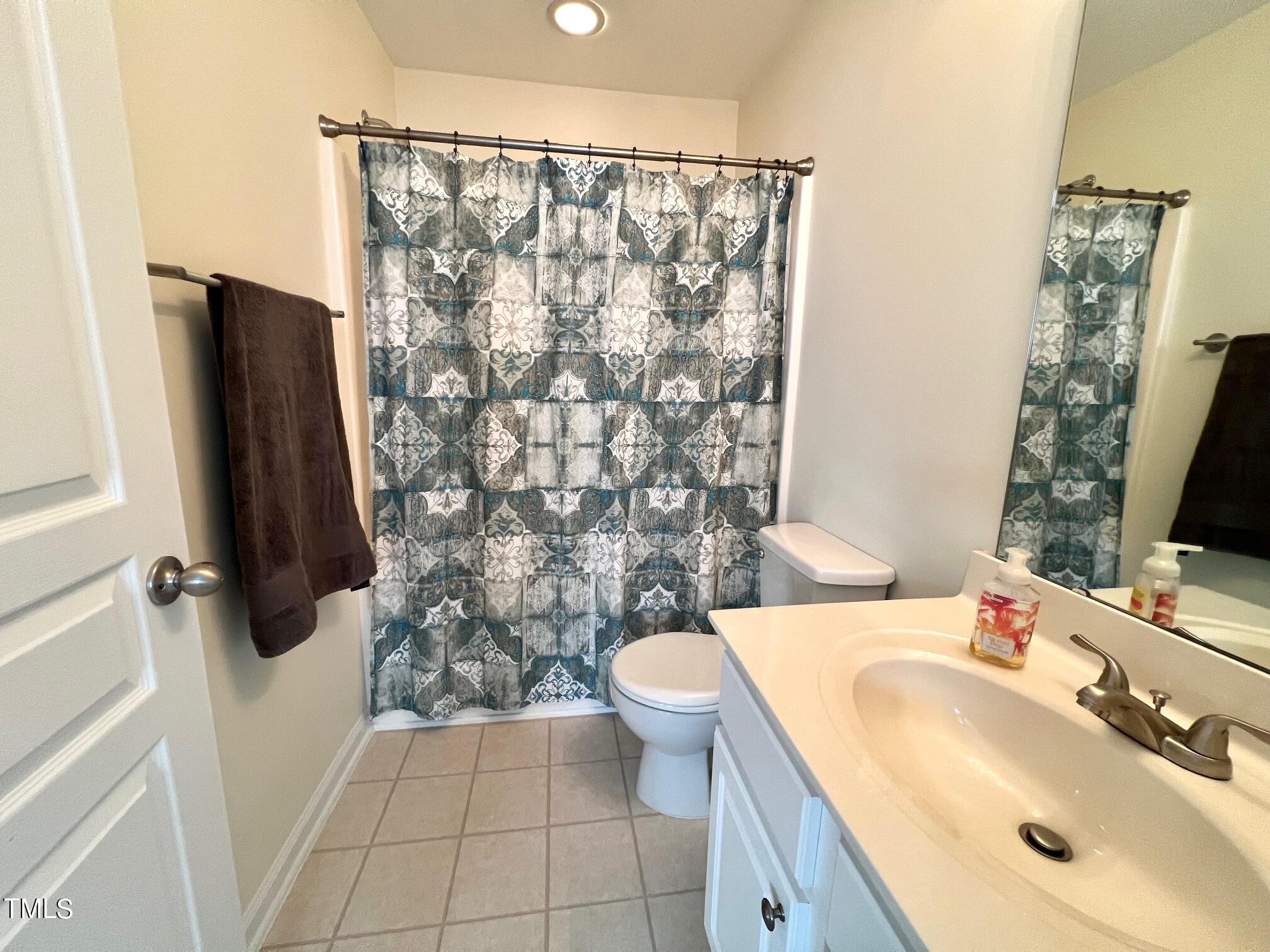 7652 Winners Edge Street Raleigh, NC 27617 - Photo 15 of 16 a bathroom with a sink toilet and shower