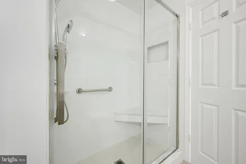 a bathroom with a glass shower door