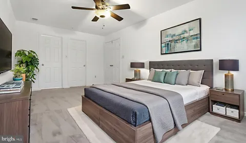 a spacious bedroom with a bed and a chandelier