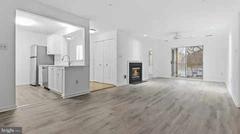 a view of kitchen with granite countertop cabinets and wooden floor