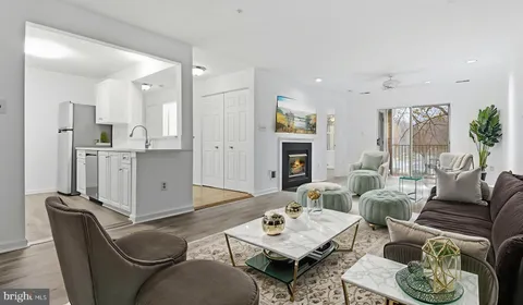 a living room with furniture kitchen view and a fireplace
