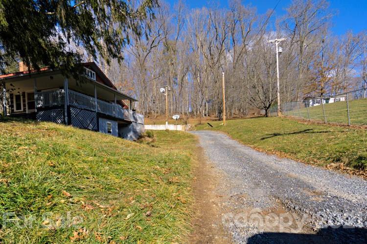 4904 Crabtree Mountain Road Clyde, NC 28721 - Photo 2 of 37 a view of a yard with large trees