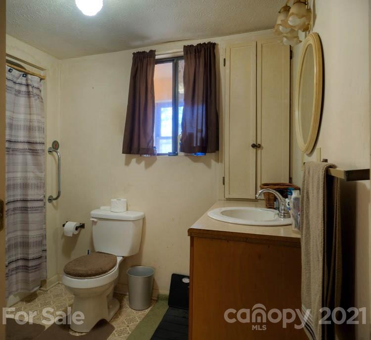 4904 Crabtree Mountain Road Clyde, NC 28721 - Photo 18 of 37 a bathroom with a sink toilet and shower