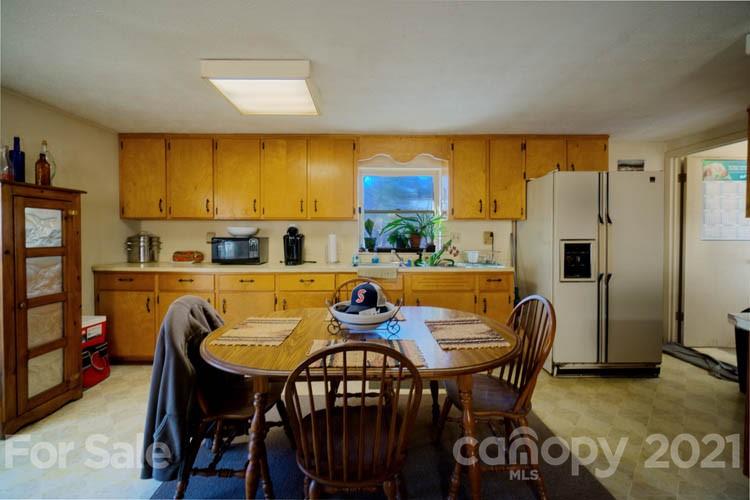 4904 Crabtree Mountain Road Clyde, NC 28721 - Photo 22 of 37 a view of a dining room with furniture and a window