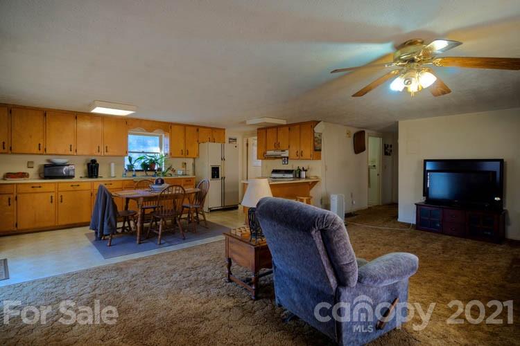 4904 Crabtree Mountain Road Clyde, NC 28721 - Photo 24 of 37 a living room with furniture and a flat screen tv