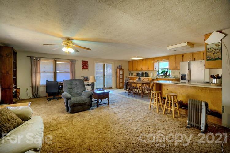 4904 Crabtree Mountain Road Clyde, NC 28721 - Photo 25 of 37 a living room with furniture and a large window