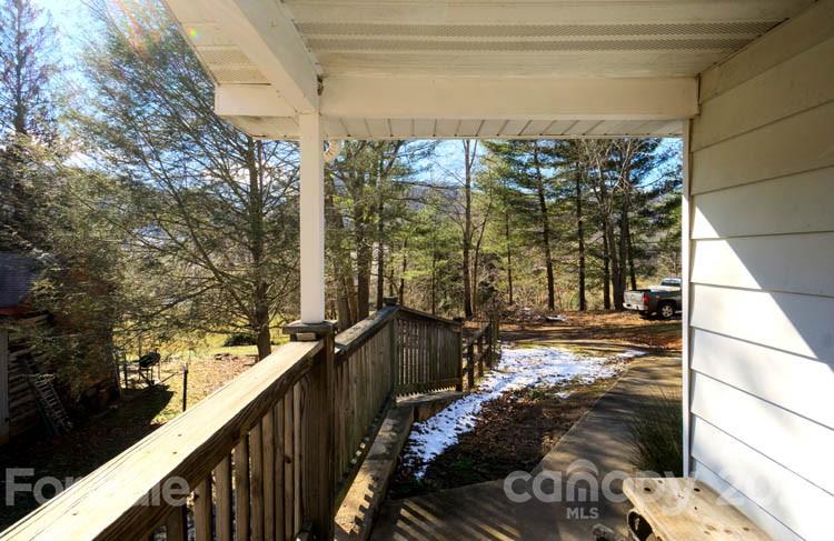 4904 Crabtree Mountain Road Clyde, NC 28721 - Photo 28 of 37 a view of a balcony with floor to ceiling windows and wooden fence