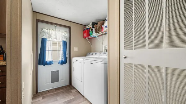 a bathroom with a granite countertop sink a toilet and a shower curtain