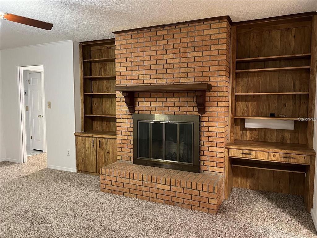 1201 Wolverine Trail Winter Springs, FL 32708 - Photo 12 of 29 a living room with a fireplace and a walk in closet