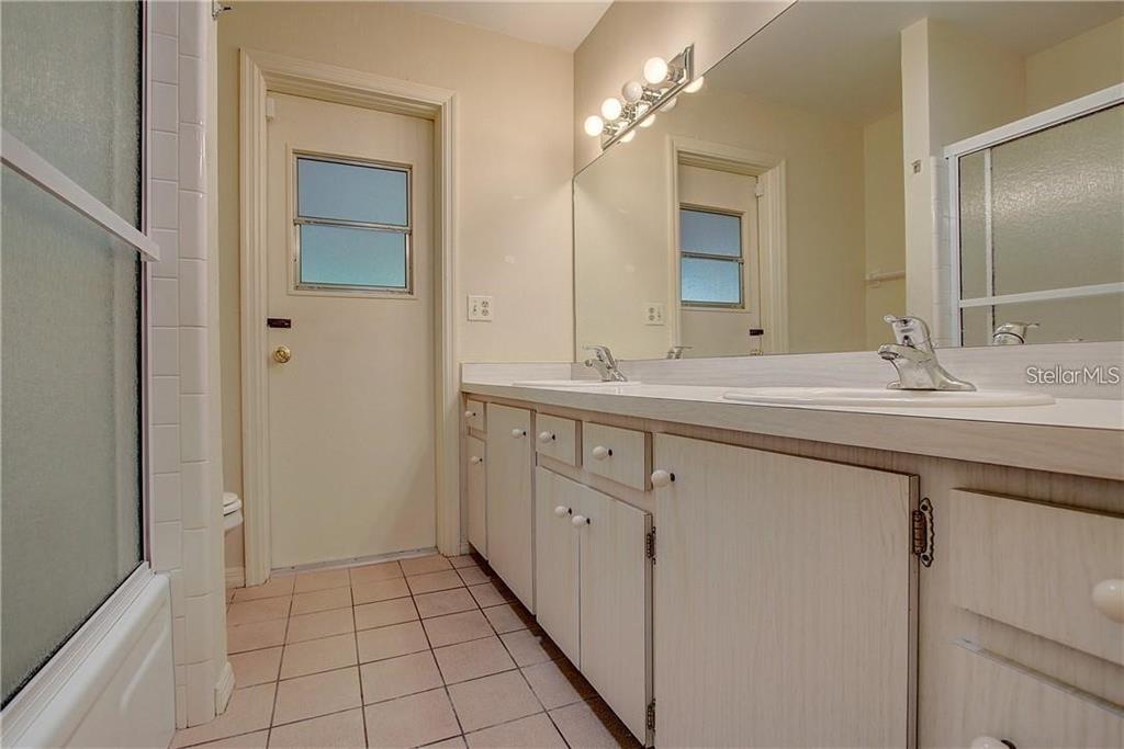 1201 Wolverine Trail Winter Springs, FL 32708 - Photo 21 of 29 a bathroom with a sink a vanity and a mirror