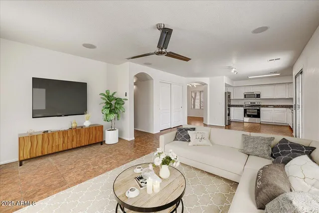 a living room with furniture and a flat screen tv