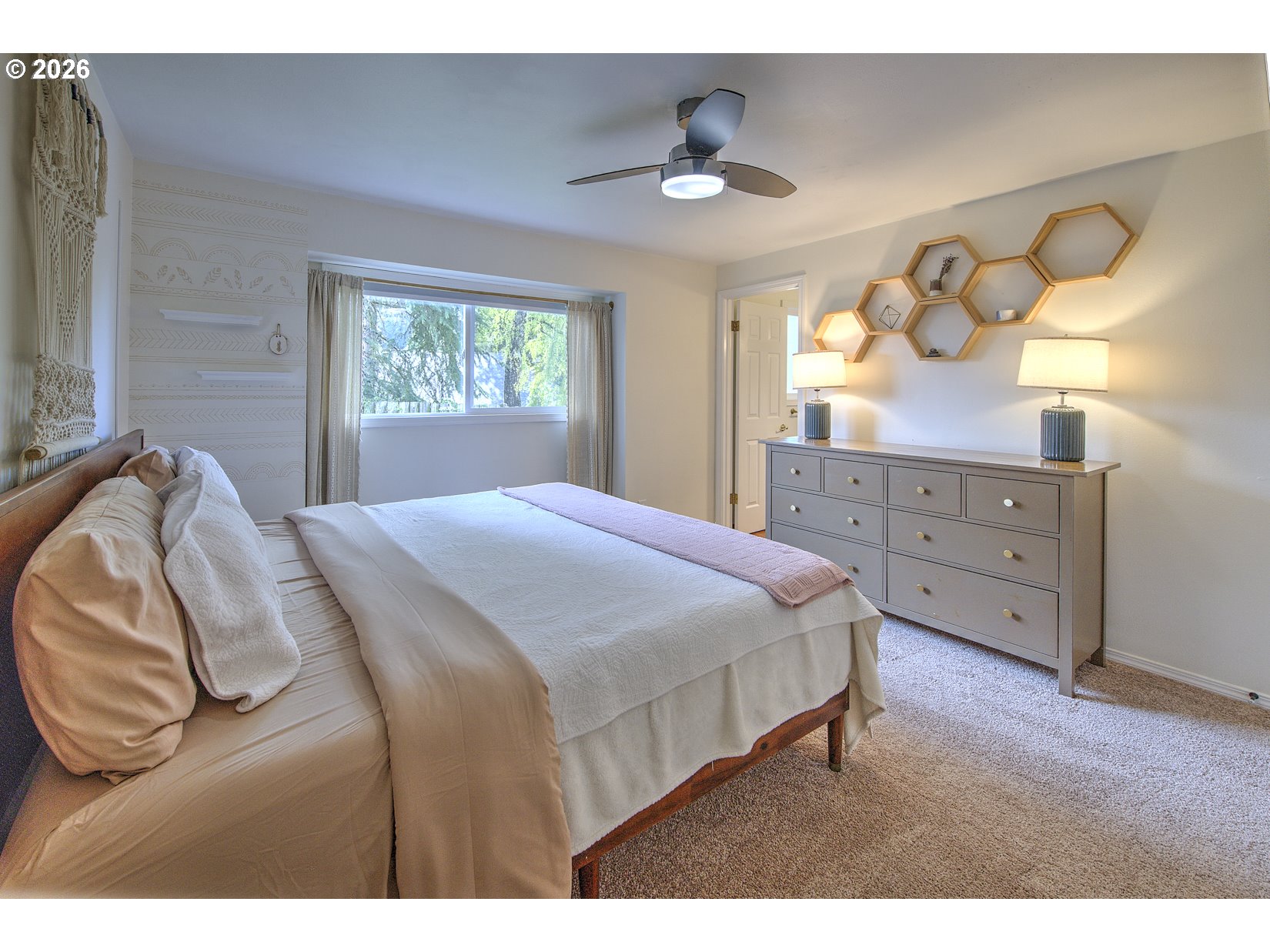 16020 Southwest Rosa Road Beaverton, OR 97007 - Photo 11 of 42 a bedroom with a bed and a chandelier