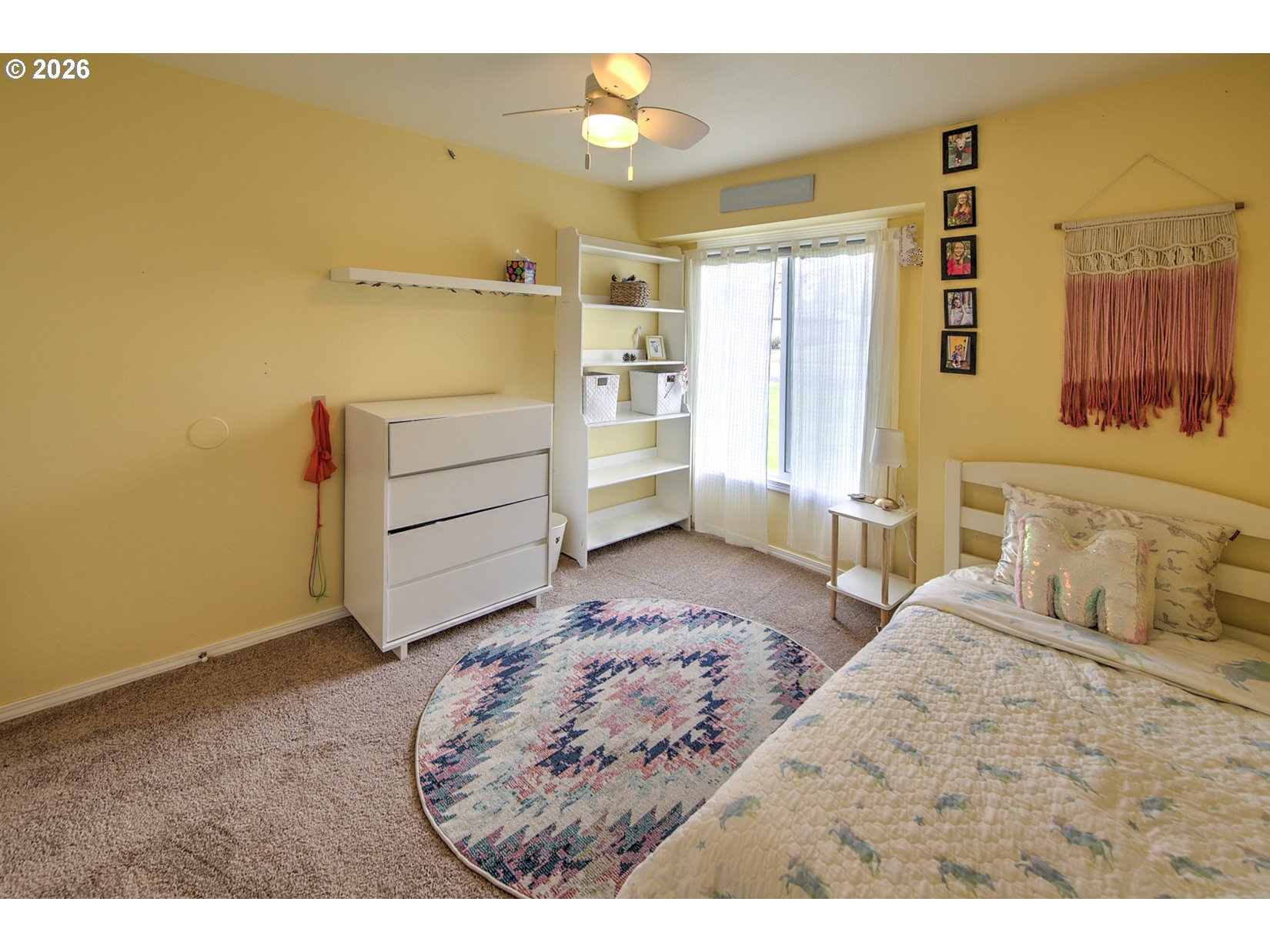 16020 Southwest Rosa Road Beaverton, OR 97007 - Photo 15 of 42 a bedroom with a bed and a chandelier