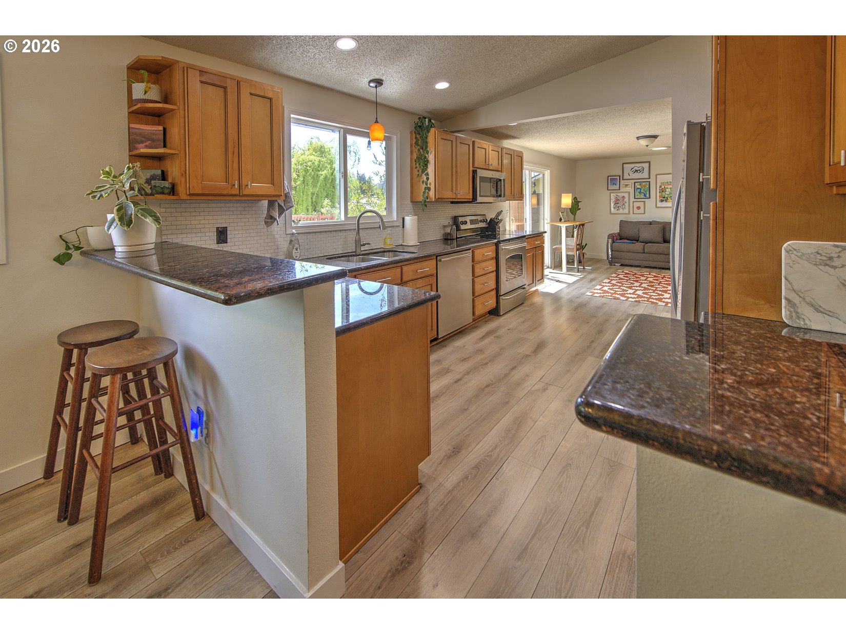 16020 Southwest Rosa Road Beaverton, OR 97007 - Photo 24 of 42 a kitchen with stainless steel appliances granite countertop a sink stove and a refrigerator