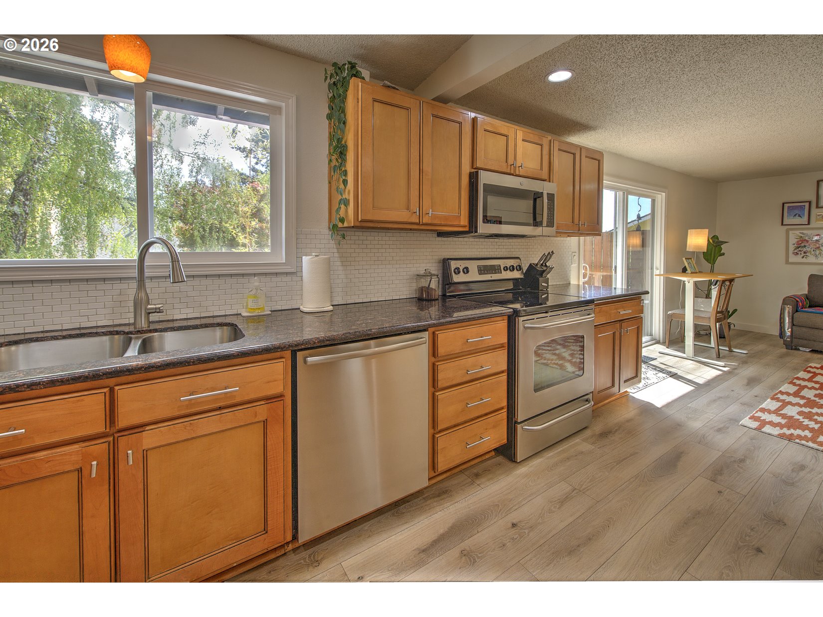16020 Southwest Rosa Road Beaverton, OR 97007 - Photo 26 of 42 a kitchen with stainless steel appliances granite countertop a stove sink and cabinets