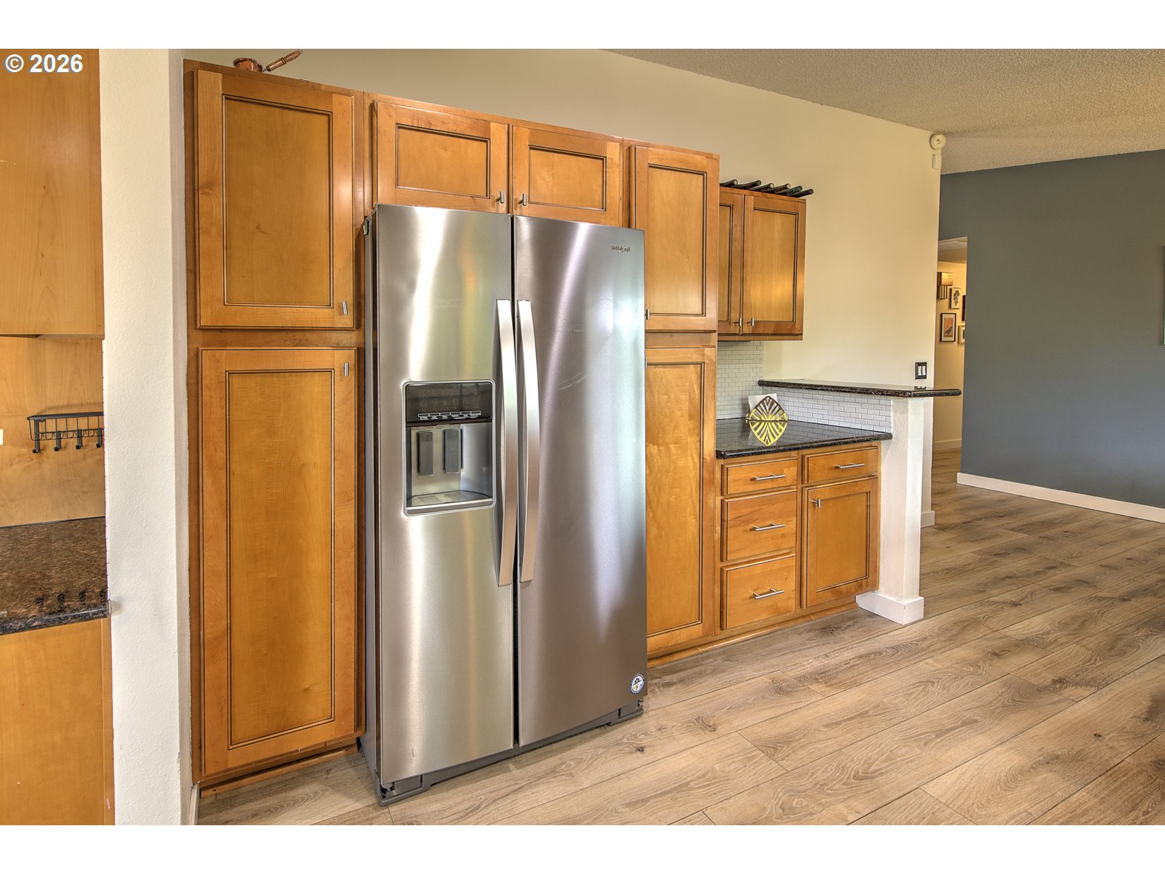 16020 Southwest Rosa Road Beaverton, OR 97007 - Photo 30 of 42 a kitchen with stainless steel appliances a refrigerator and a wooden floor
