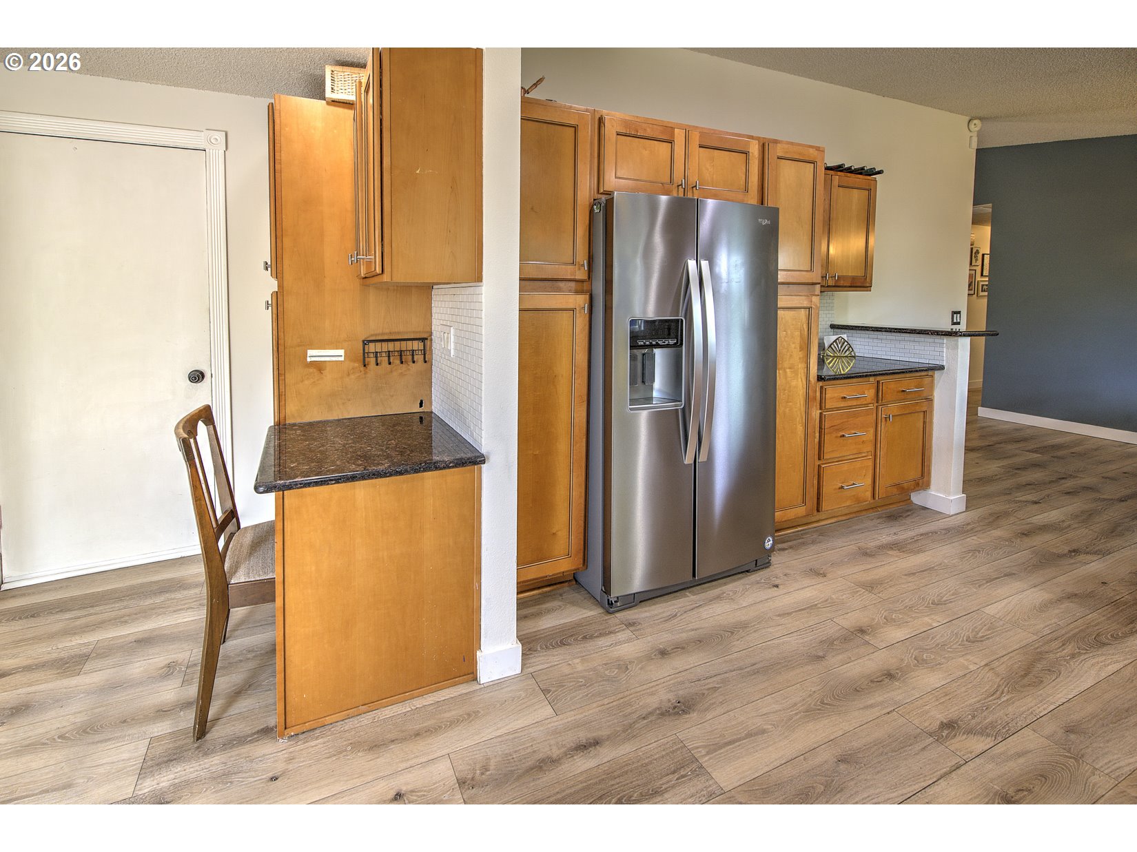 16020 Southwest Rosa Road Beaverton, OR 97007 - Photo 31 of 42 a kitchen with stainless steel appliances wooden floor and a refrigerator