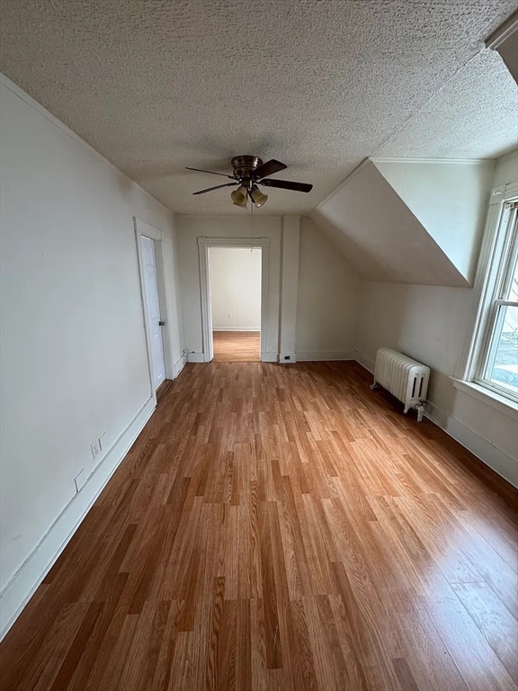 78 Birch Street, Unit 2 Worcester, MA 01603 - Photo 4 of 12 wooden floor in an empty room with a window