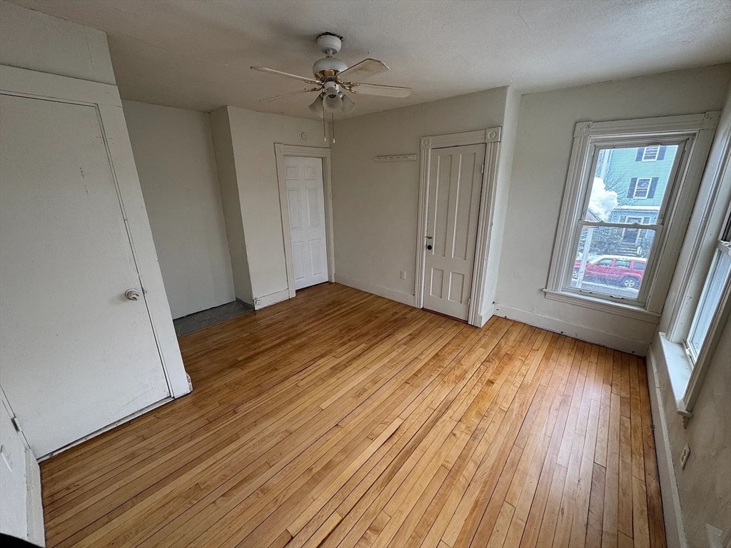 78 Birch Street, Unit 2 Worcester, MA 01603 - Photo 9 of 12 a view of empty room with wooden floor and fan