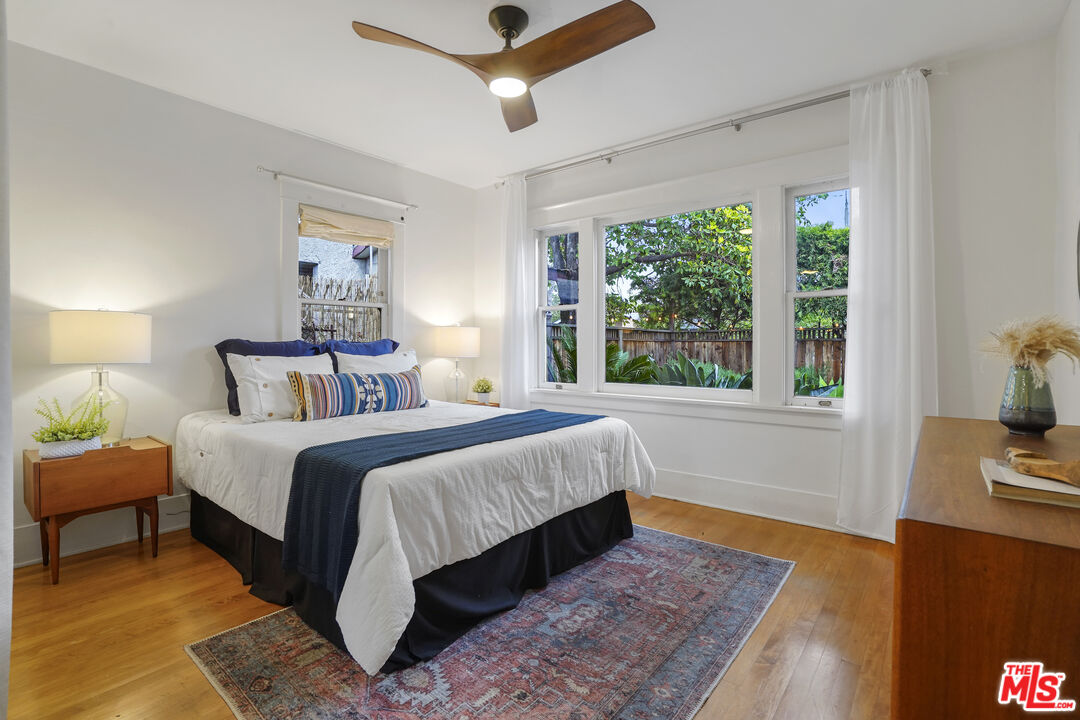 337 Cherry Avenue Long Beach, CA 90802 - Photo 25 of 52 a bedroom with a bed lamps and window