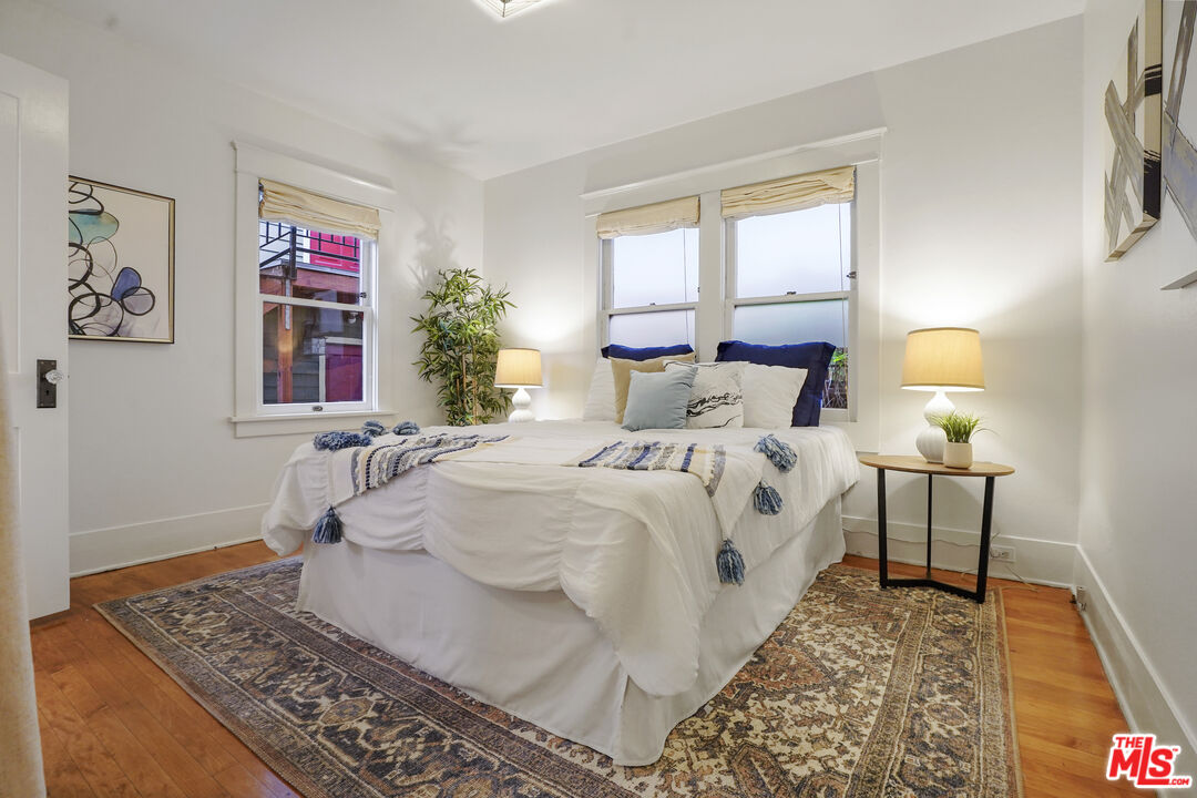 337 Cherry Avenue Long Beach, CA 90802 - Photo 30 of 52 a bedroom with a bed and wooden floor