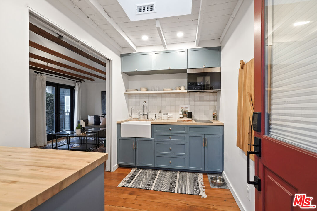 337 Cherry Avenue Long Beach, CA 90802 - Photo 37 of 52 a kitchen with stainless steel appliances granite countertop a sink and cabinets