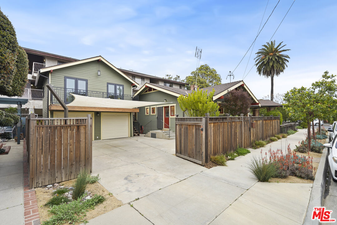 337 Cherry Avenue Long Beach, CA 90802 - Photo 7 of 52 a view of a white house with wooden fence next to a yard