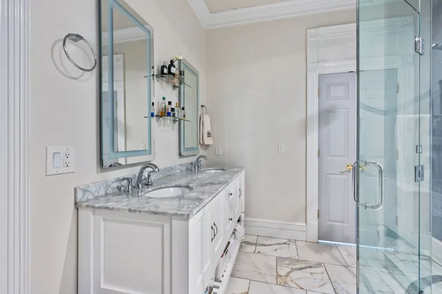a bathroom with a double vanity sink and mirror