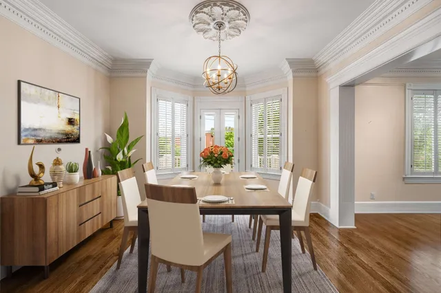 a dining room with wooden floor a chandelier a wooden table and chairs