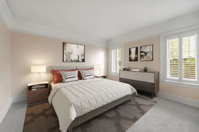 a bedroom with a bed couch and window